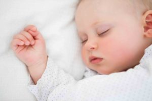 Peaceful baby lying on a bed while sleeping